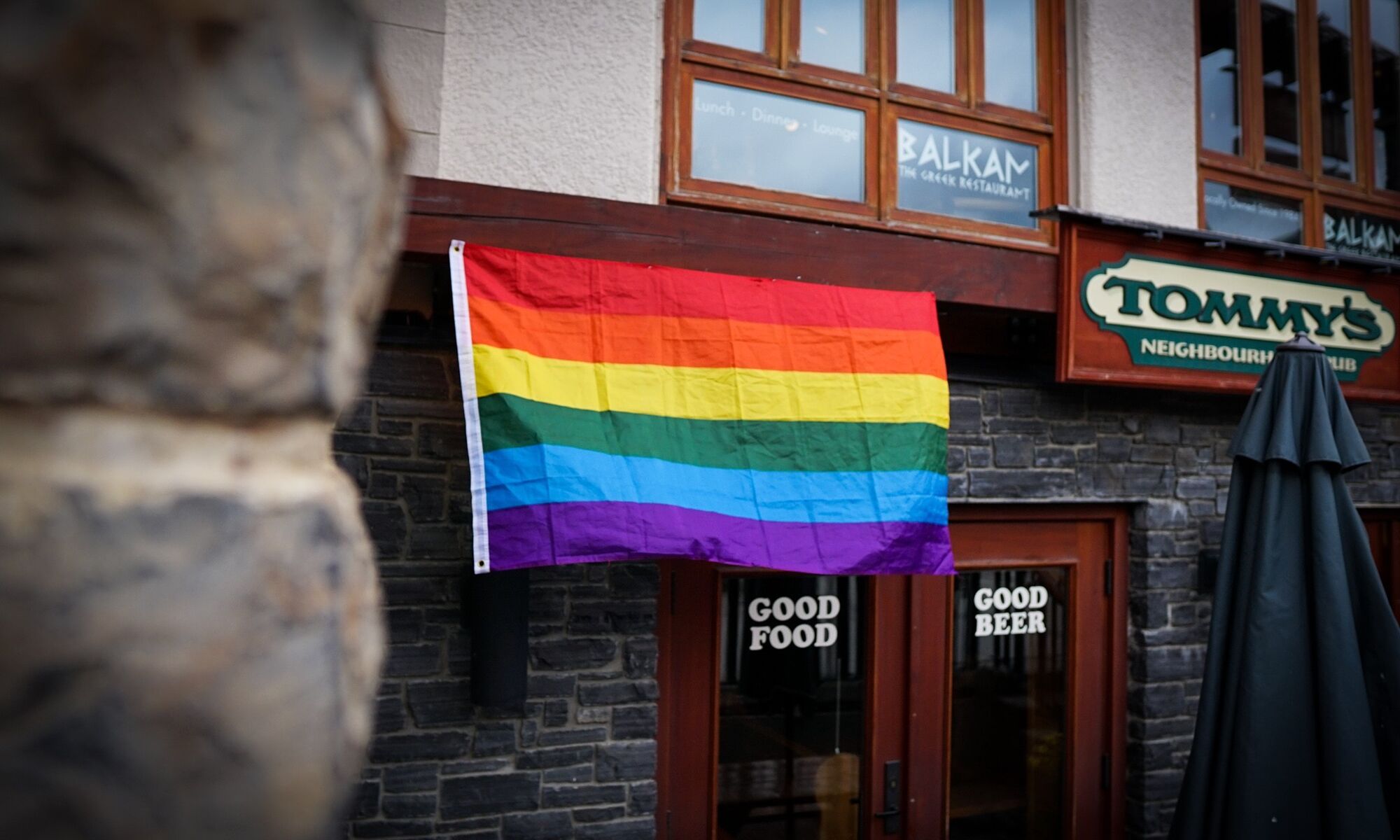 Banff Pride flag in front of Tommy's Neighborhood Pub.